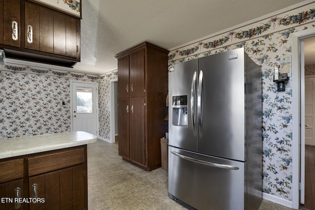 610 Hudson St, Athens, TN 37303 - kitchen featuring light countertops, a textured ceiling, stainless steel fridge, baseboards, and wallpapered walls