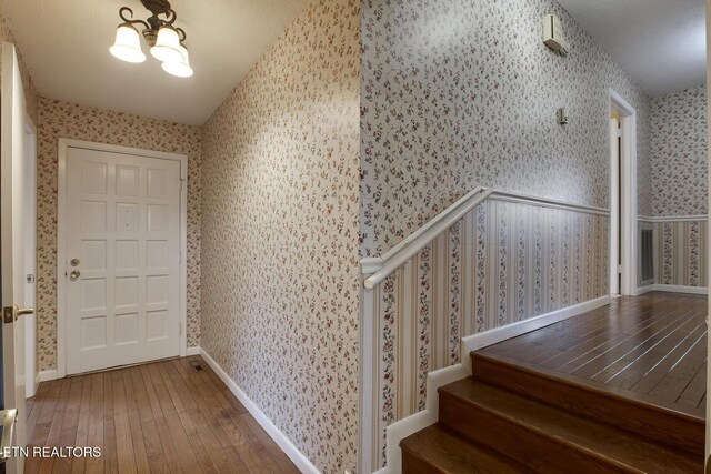 610 Hudson St, Athens, TN 37303 - foyer entrance featuring a notable chandelier, wallpapered walls, hardwood / wood-style floors, baseboards, and stairs