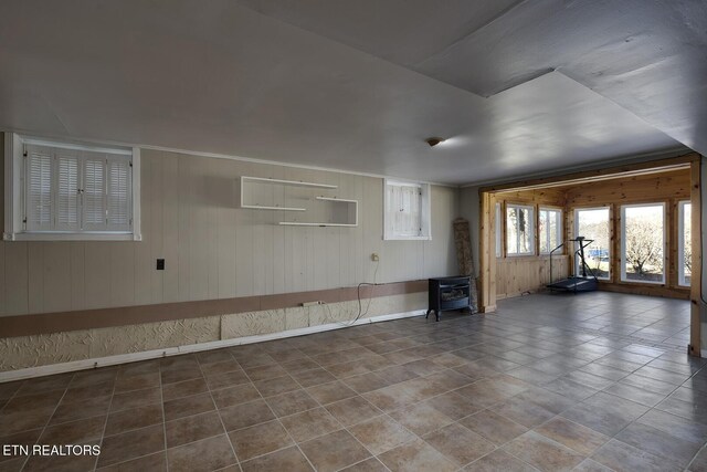 610 Hudson St, Athens, TN 37303 - empty room featuring baseboards, a wood stove, and tile patterned floors