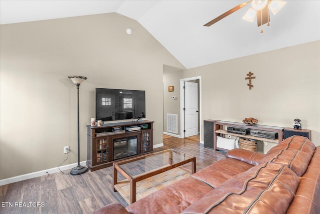 living area with a ceiling fan, visible vents, baseboards, and wood finished floors