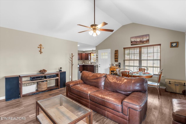 living room with vaulted ceiling, wood finished floors, a ceiling fan, and baseboards