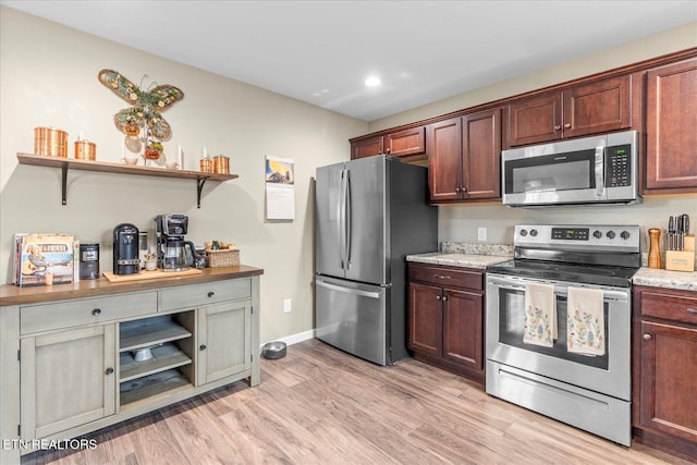 kitchen with stainless steel appliances, open shelves, light wood-style flooring, and baseboards