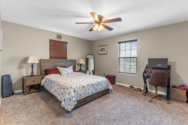 carpeted bedroom with a ceiling fan and baseboards