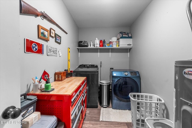 laundry room featuring washer and clothes dryer and wood finished floors