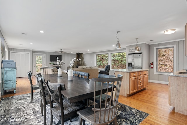 dining area with crown molding, recessed lighting, baseboards, and light wood-style floors