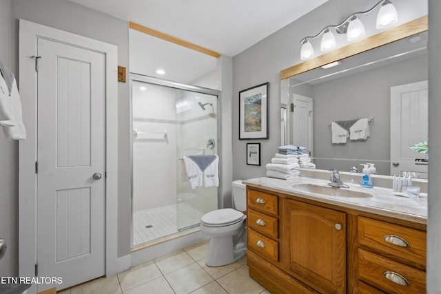 full bathroom featuring toilet, a stall shower, vanity, and tile patterned floors