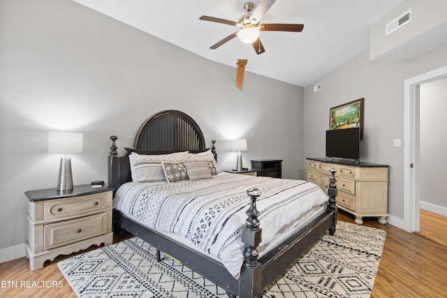 bedroom featuring light wood-style flooring, visible vents, and baseboards