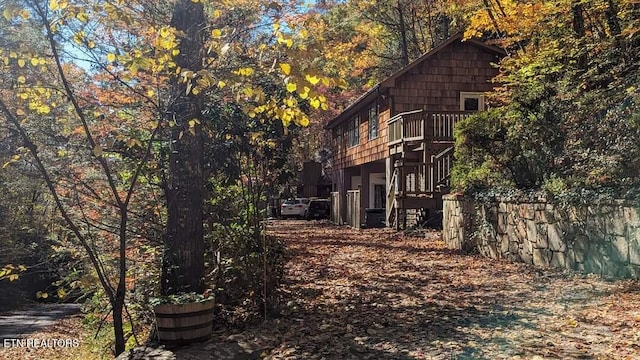 view of side of property featuring stairs