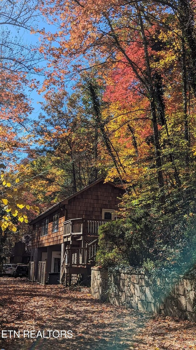 back of house with stairway and a deck