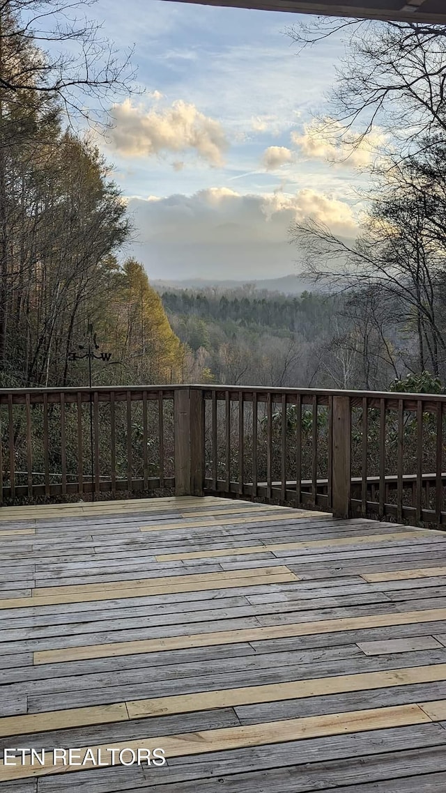 deck featuring a forest view