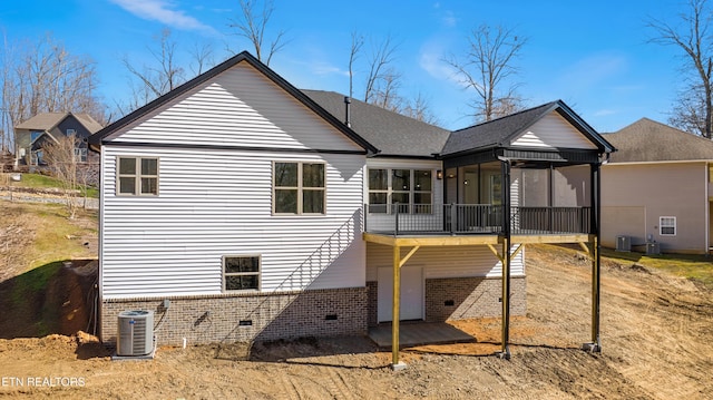 back of house featuring roof with shingles, a sunroom, crawl space, central air condition unit, and brick siding