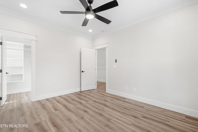 unfurnished bedroom with crown molding, baseboards, and light wood finished floors