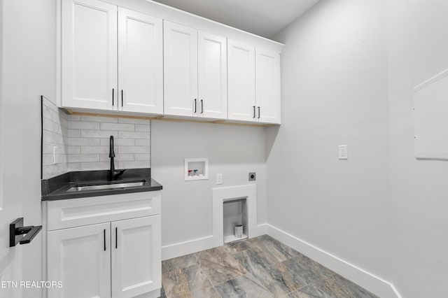 washroom with electric dryer hookup, a sink, cabinet space, baseboards, and hookup for a washing machine