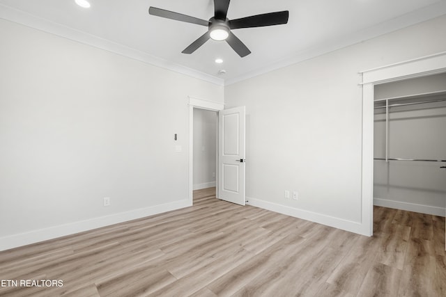 unfurnished bedroom featuring wood finished floors, recessed lighting, a closet, crown molding, and baseboards