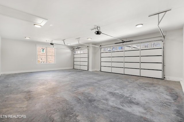 garage featuring a garage door opener and baseboards