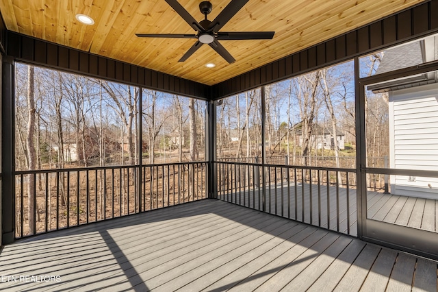 unfurnished sunroom featuring ceiling fan and wooden ceiling