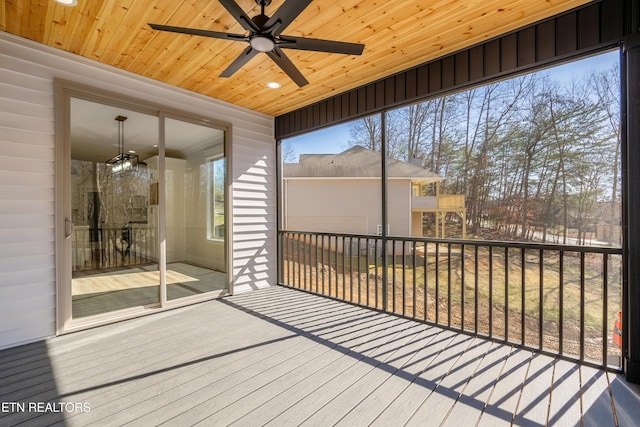 unfurnished sunroom with wooden ceiling and ceiling fan