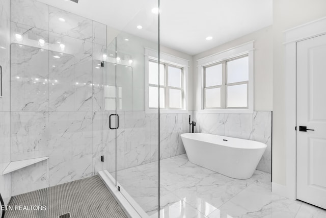 full bathroom featuring a marble finish shower, a freestanding tub, marble finish floor, and recessed lighting