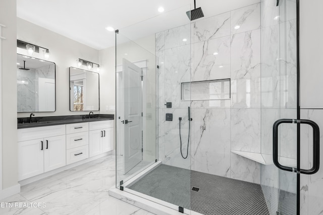 full bath with a sink, a marble finish shower, and marble finish floor