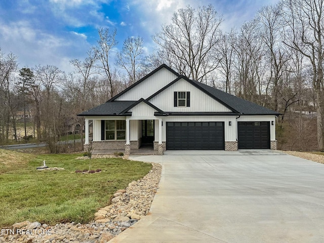 modern farmhouse featuring brick siding, an attached garage, concrete driveway, and a front lawn