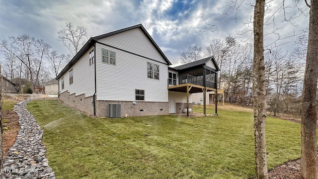 back of property with a yard and central air condition unit