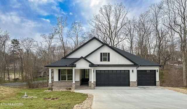 modern inspired farmhouse with driveway, a shingled roof, a front lawn, a garage, and brick siding