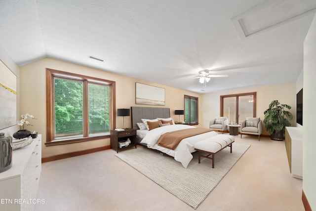 bedroom with visible vents, attic access, carpet, a ceiling fan, and vaulted ceiling