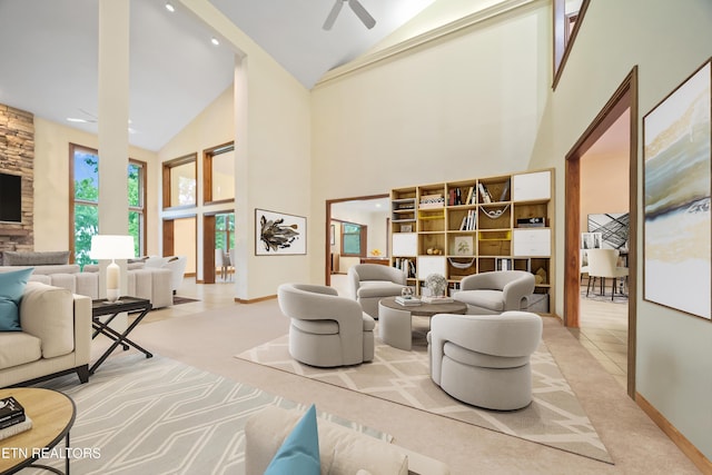living area with high vaulted ceiling, baseboards, a ceiling fan, and carpet floors