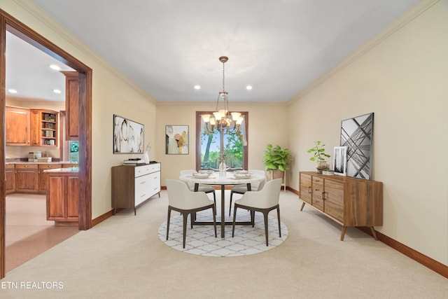 dining space featuring crown molding, a chandelier, baseboards, and light colored carpet