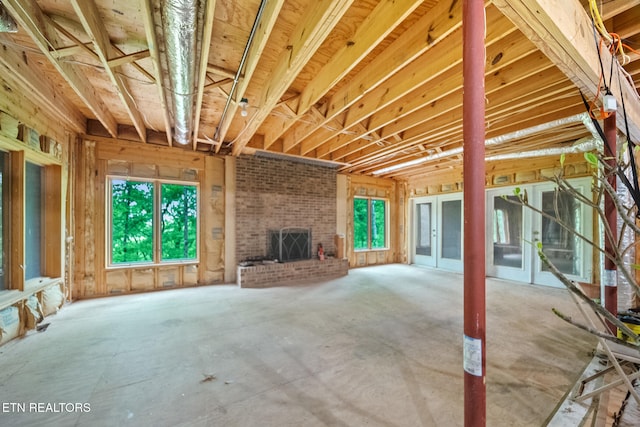 unfurnished living room with plenty of natural light and a fireplace