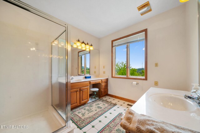 full bathroom with vanity, baseboards, tile patterned floors, and a shower stall