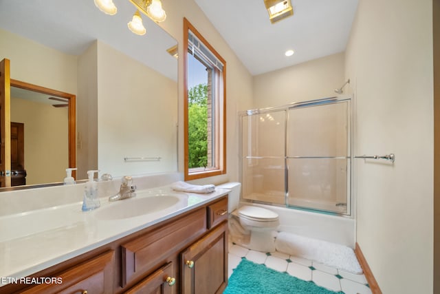 full bath featuring toilet, tile patterned floors, shower / bath combination with glass door, and vanity