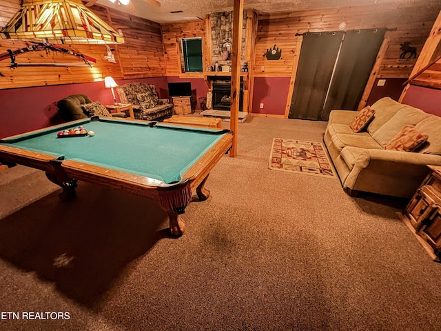 game room featuring carpet, wood walls, a textured ceiling, and billiards