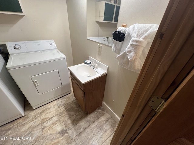 laundry area featuring a sink and washer / dryer