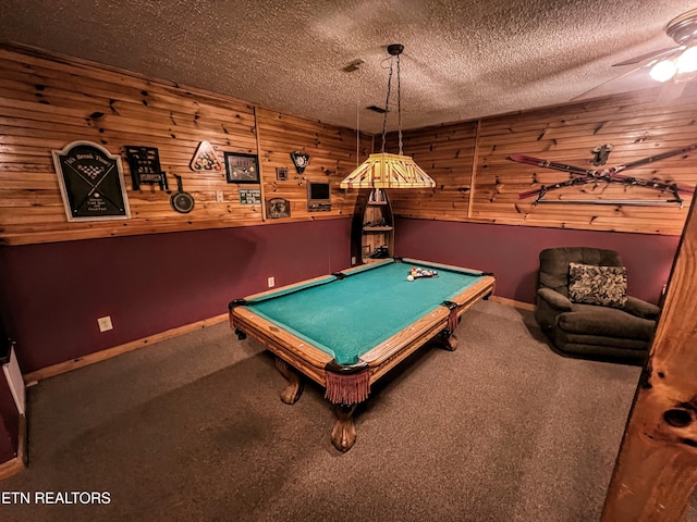 recreation room with a textured ceiling, wood walls, billiards, carpet flooring, and baseboards