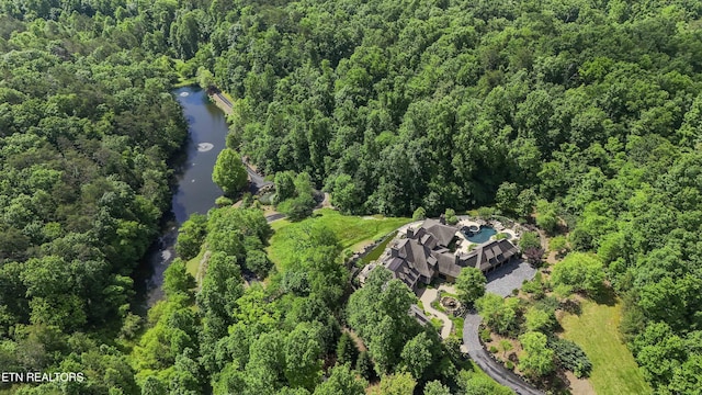 drone / aerial view with a wooded view