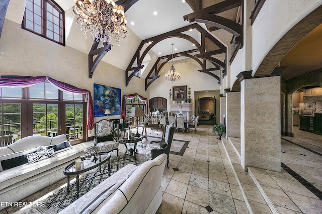 interior space featuring arched walkways, recessed lighting, stone tile flooring, a towering ceiling, and a chandelier