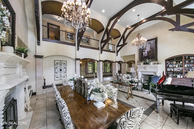 interior space featuring a fireplace, high vaulted ceiling, recessed lighting, a chandelier, and baseboards