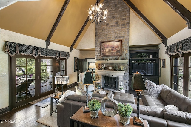 living room featuring hardwood / wood-style flooring, an inviting chandelier, french doors, a fireplace, and high vaulted ceiling