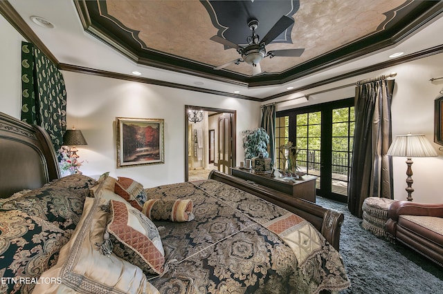 bedroom featuring ensuite bath, access to outside, a tray ceiling, crown molding, and french doors