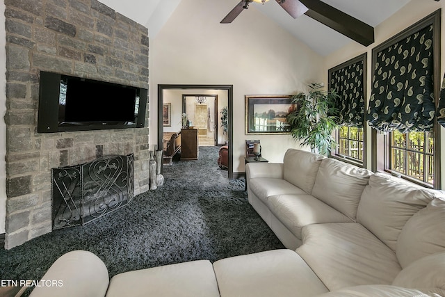 carpeted living area featuring high vaulted ceiling, a ceiling fan, beamed ceiling, and a stone fireplace