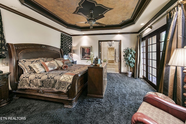 carpeted bedroom featuring ceiling fan, ensuite bath, a raised ceiling, and crown molding