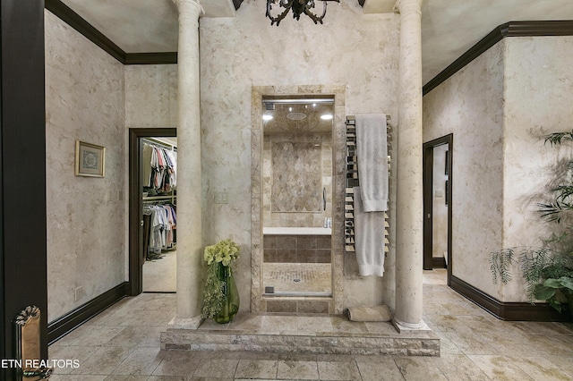 full bath with a towering ceiling, a stall shower, decorative columns, and baseboards