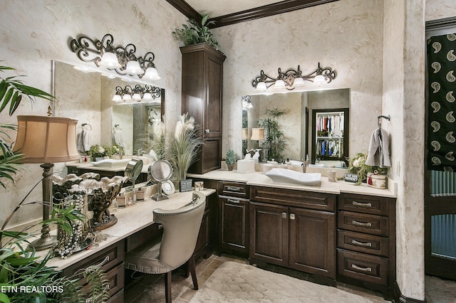 bathroom with ornamental molding and vanity