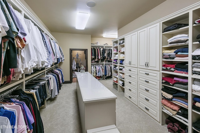 walk in closet featuring carpet flooring