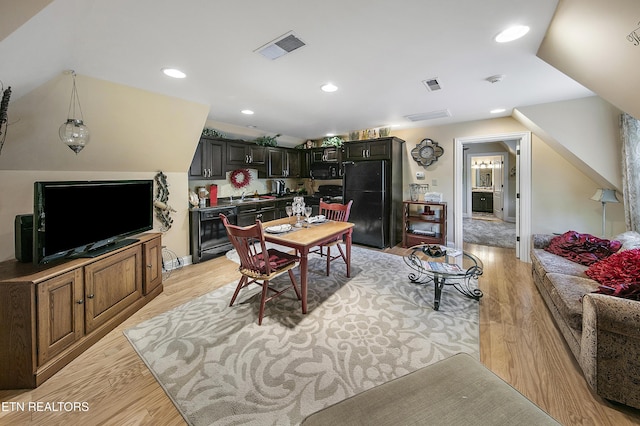 dining space featuring lofted ceiling, light wood-type flooring, visible vents, and recessed lighting