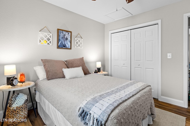 bedroom featuring ceiling fan, dark wood-style flooring, baseboards, a closet, and attic access