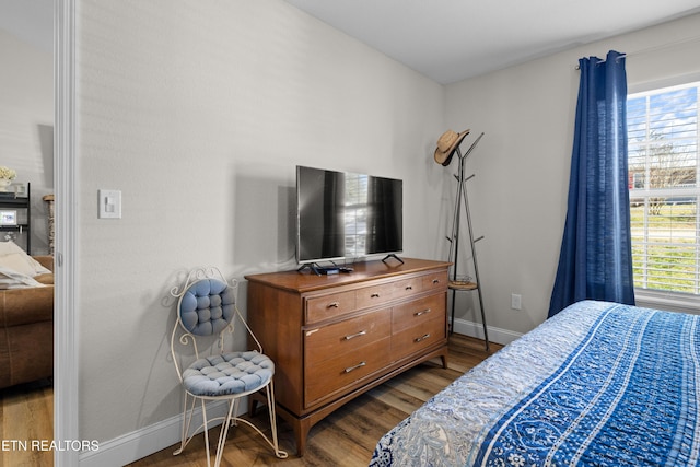 bedroom featuring baseboards and wood finished floors