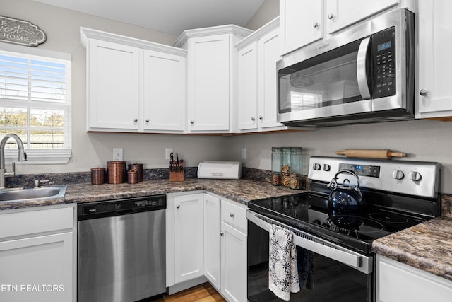 kitchen featuring white cabinetry, appliances with stainless steel finishes, and a sink