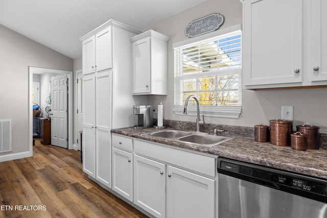 kitchen featuring dark wood-style floors, a sink, white cabinets, vaulted ceiling, and dishwasher